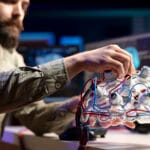 Computer scientist installing electrodes wires on EEG headset
