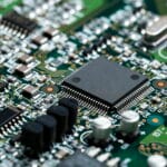 Closeup of electronic circuit board with CPU microchip electronic components background
