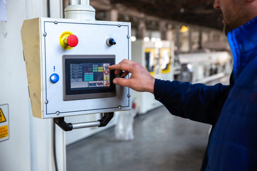 worker uses control panel in factory